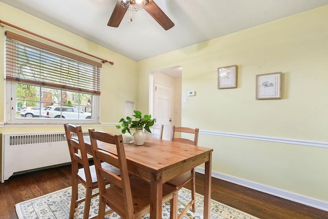 dining room with ceiling fan, radiator heating unit, wood finished floors, and baseboards