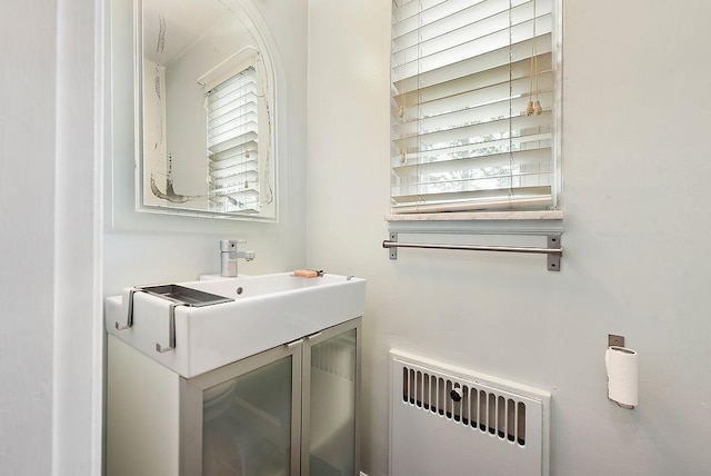bathroom featuring radiator heating unit and vanity