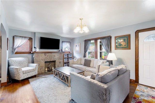 57 Laurel Ave, City Of Washington, PA 15301 - living area with a chandelier, a fireplace, dark wood-style flooring, arched walkways, and baseboards