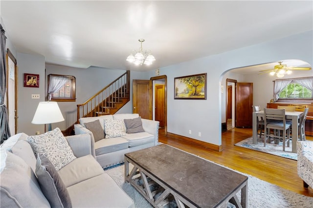 57 Laurel Ave, City Of Washington, PA 15301 - living room featuring arched walkways, wood finished floors, a chandelier, stairway, and a ceiling fan