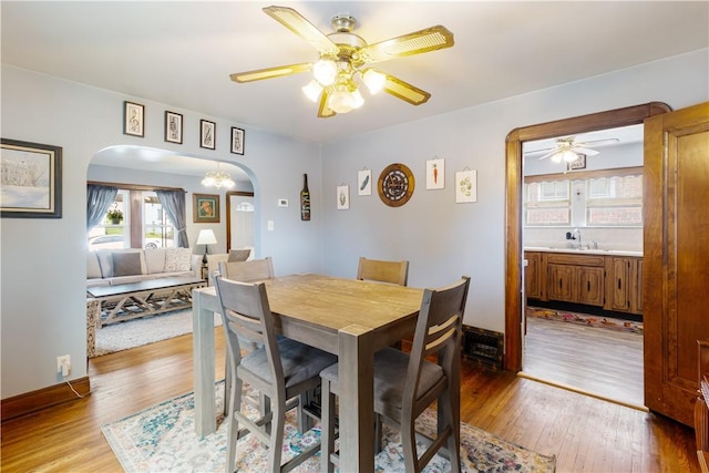 57 Laurel Ave, City Of Washington, PA 15301 - dining space featuring ceiling fan, arched walkways, and light wood-type flooring