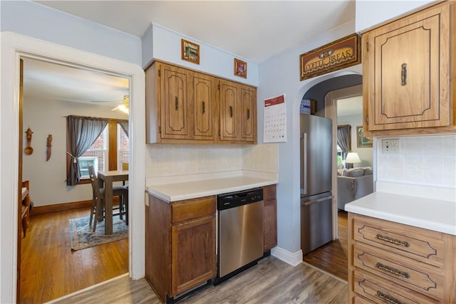 57 Laurel Ave, City Of Washington, PA 15301 - kitchen with stainless steel appliances, arched walkways, wood finished floors, and decorative backsplash