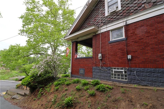 view of side of home featuring brick siding