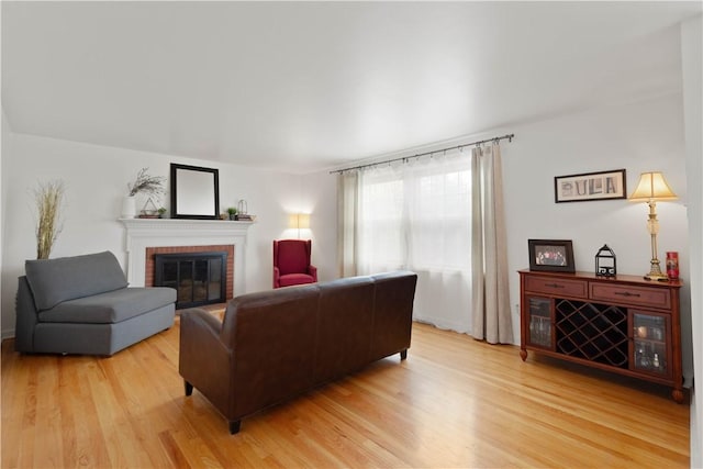 living area with light wood finished floors and a fireplace