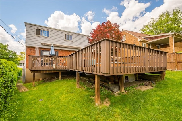 back of house featuring brick siding and a deck