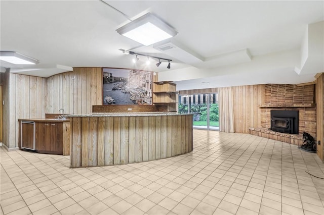 46 Churchill Rd, Churchill Boro, PA 15235 - kitchen with wood walls, open floor plan, rail lighting, light tile patterned floors, and dishwasher