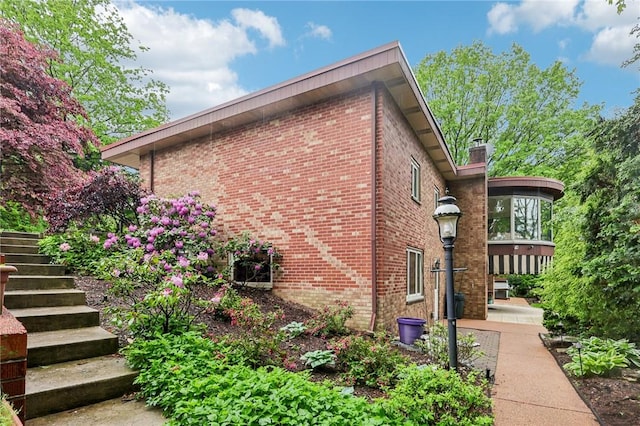 46 Churchill Rd, Churchill Boro, PA 15235 - view of side of property featuring brick siding, stairway, and a chimney