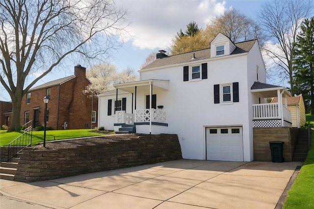 5222 Fieldcrest Dr, Whitehall, PA 15236 - view of front of property with a garage, concrete driveway, stucco siding, and a front yard