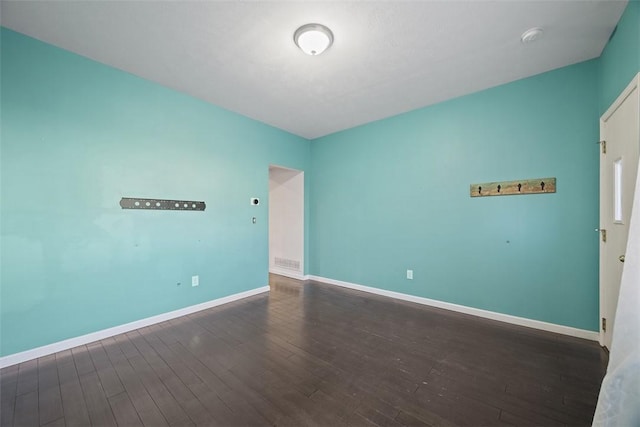 spare room with hardwood / wood-style flooring, baseboards, and a smoke detector
