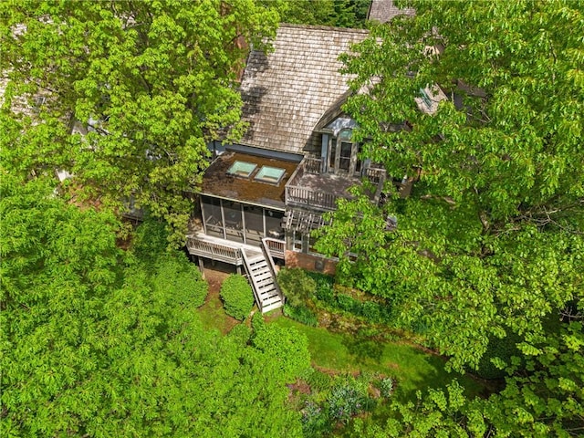 back of house featuring a sunroom, stairway, and a chimney