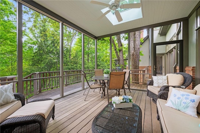 sunroom / solarium featuring ceiling fan, an outdoor hangout area, a skylight, and plenty of natural light