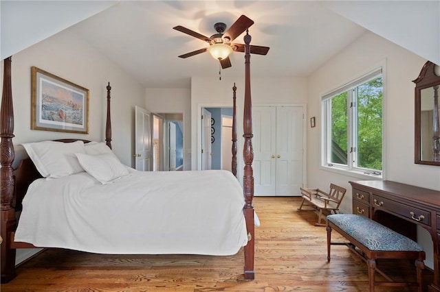 bedroom with light wood finished floors, ceiling fan, and a closet