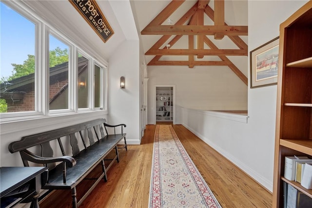 hallway with wood finished floors and baseboards