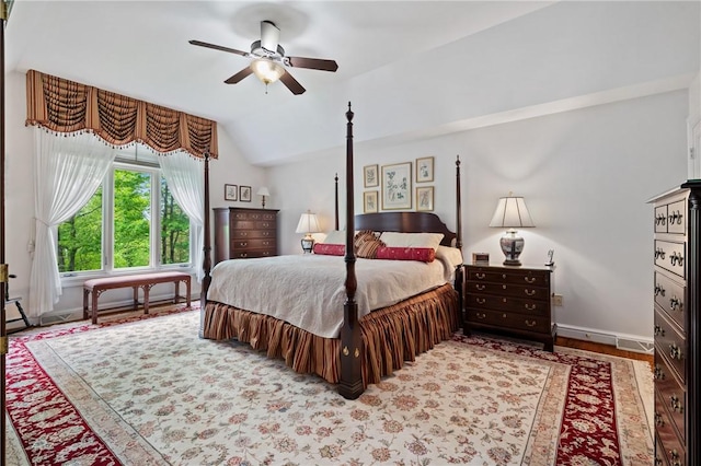 bedroom featuring lofted ceiling, baseboards, wood finished floors, and ceiling fan