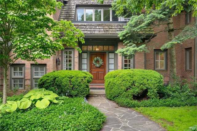 doorway to property featuring brick siding
