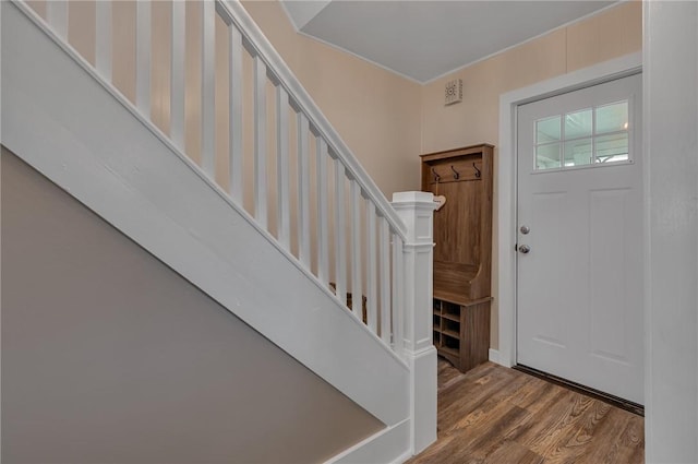 entryway with wood finished floors and stairway