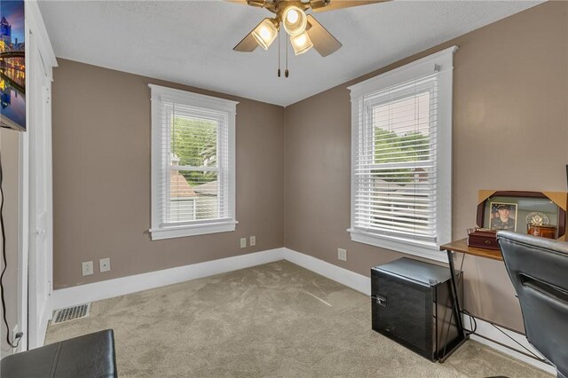 office area with ceiling fan, carpet floors, and baseboards