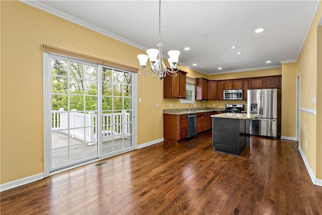 kitchen featuring appliances with stainless steel finishes, ornamental molding, baseboards, a chandelier, and light stone countertops
