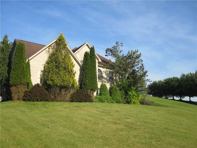 view of property exterior with a yard