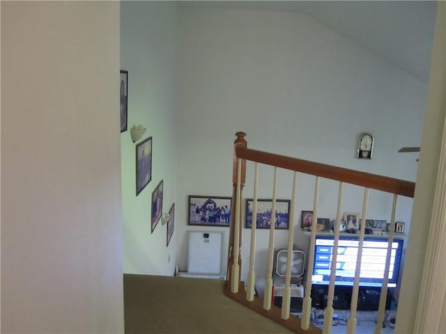 stairway featuring lofted ceiling