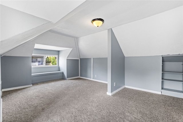 bonus room featuring carpet, baseboards, and lofted ceiling