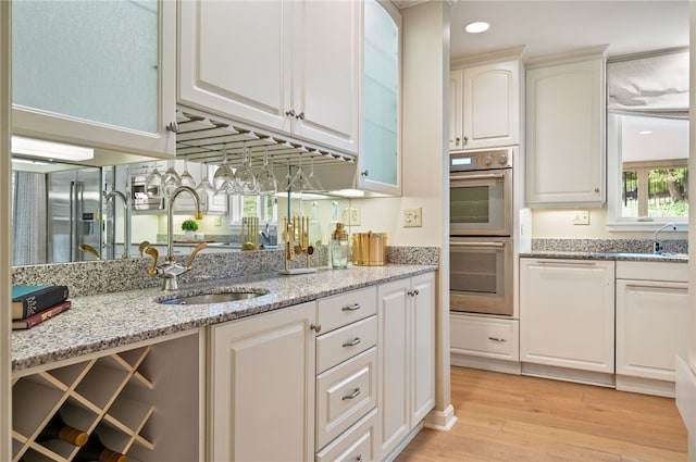 1 Way Hollow Rd, Edgeworth, PA 15143 - kitchen with stainless steel appliances, a sink, light wood-style flooring, and white cabinets