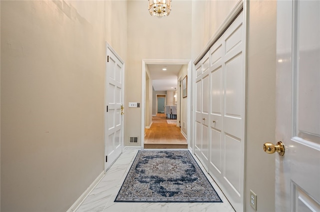 1 Way Hollow Rd, Edgeworth, PA 15143 - hall with a chandelier, baseboards, and light marble finish flooring