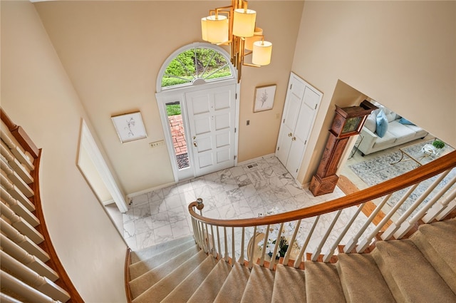 1 Way Hollow Rd, Edgeworth, PA 15143 - entrance foyer featuring marble finish flooring, a high ceiling, stairs, and baseboards