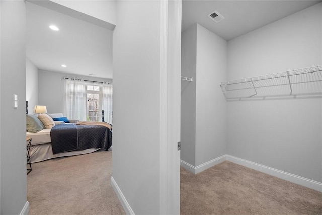 walk in closet featuring carpet