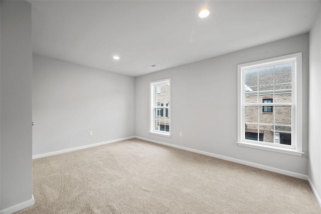 carpeted empty room with baseboards and recessed lighting