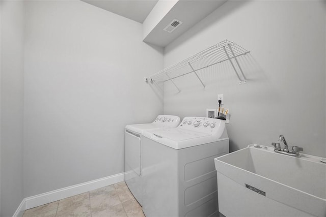 laundry room with washer and clothes dryer and baseboards