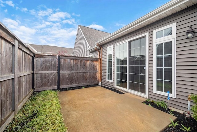 view of patio / terrace featuring fence and a gate