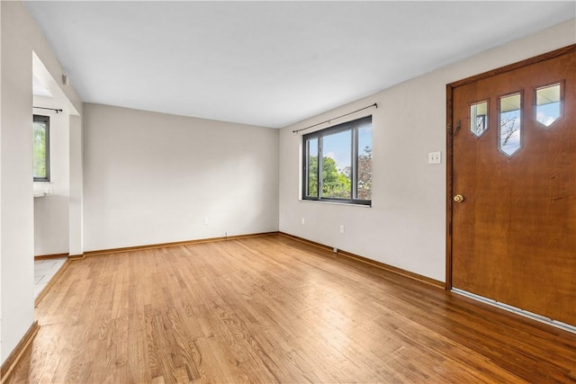 entrance foyer with light wood-style floors and baseboards
