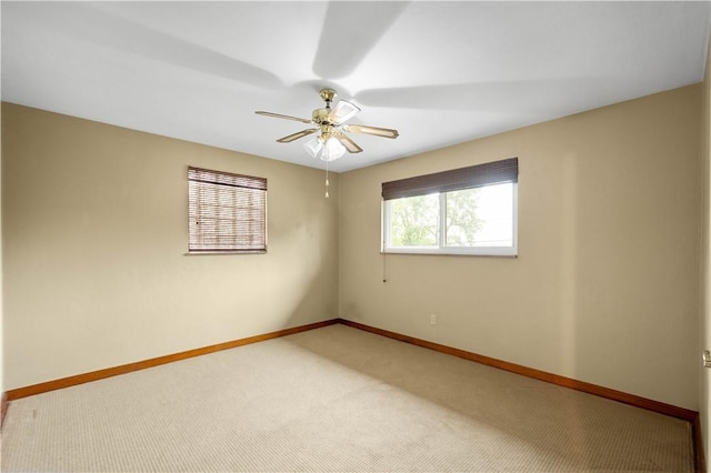 empty room featuring baseboards, carpet, and ceiling fan