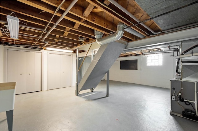 below grade area with heating unit and stairway