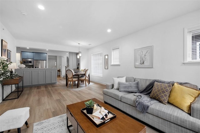 living room featuring light wood finished floors and recessed lighting