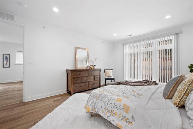 bedroom with light wood-style flooring, recessed lighting, and baseboards