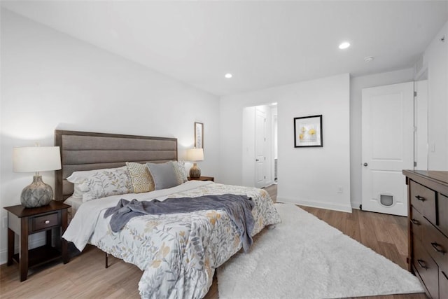 bedroom featuring light wood-type flooring, baseboards, and recessed lighting