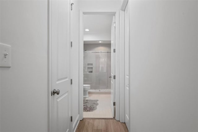 hallway featuring light wood finished floors and recessed lighting