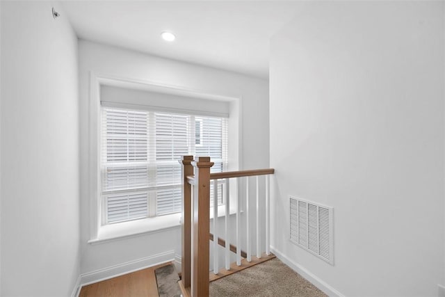 stairway with baseboards and recessed lighting