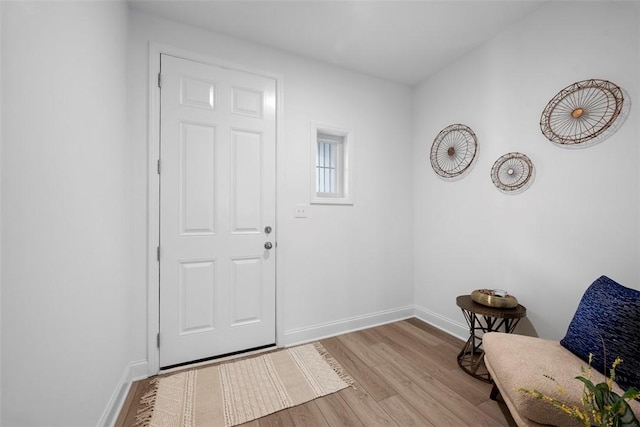foyer entrance featuring wood finished floors and baseboards