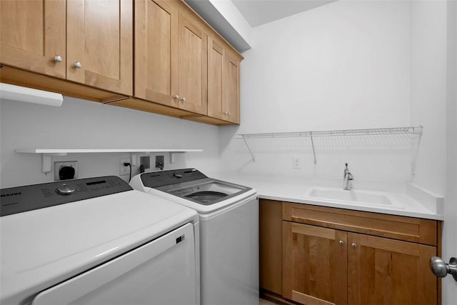 laundry room featuring washing machine and clothes dryer and cabinet space