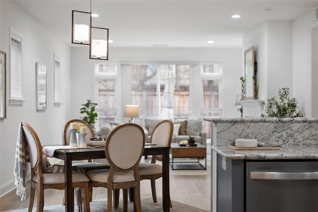dining room with wood finished floors and recessed lighting