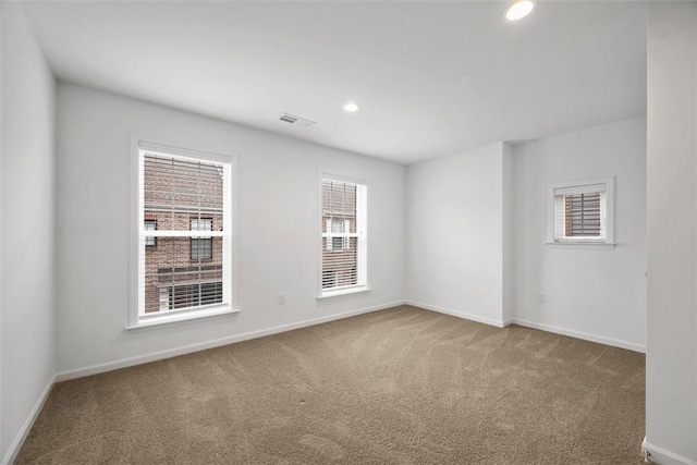 spare room with carpet flooring, baseboards, and recessed lighting
