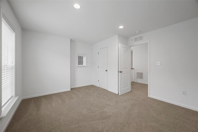 unfurnished bedroom featuring carpet flooring, recessed lighting, and baseboards