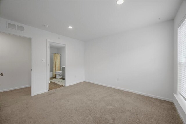unfurnished bedroom with carpet flooring, recessed lighting, baseboards, and connected bathroom