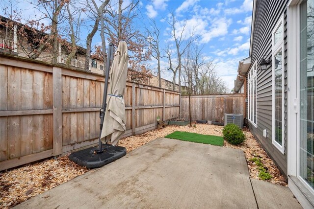 view of patio with a fenced backyard and central AC
