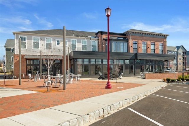 view of building exterior featuring uncovered parking