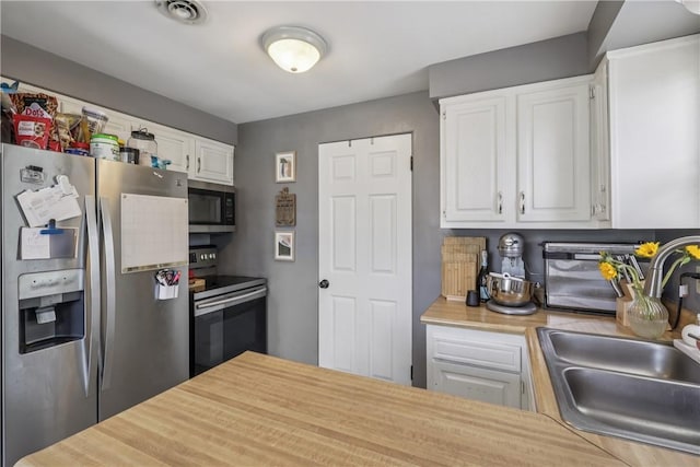 550 Mcclane Farm Rd, Chartiers, PA 15301 - kitchen featuring appliances with stainless steel finishes, a sink, light countertops, and white cabinetry