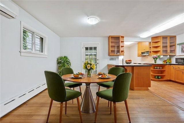 6640 Wilkins Ave, Squirrel Hill, PA 15217 - dining space featuring a baseboard radiator, an AC wall unit, plenty of natural light, and light wood-type flooring